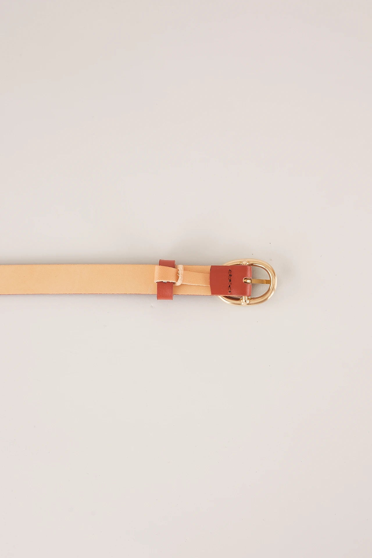 Thin leather belt with gold oval buckle